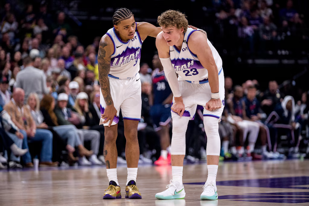 Jazz players Keyonte George and Lauri Markkanen talking during a game